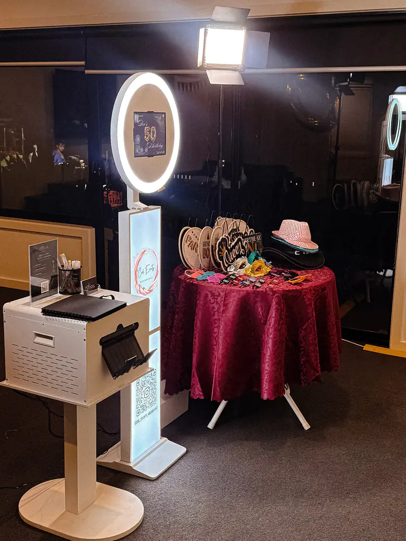 The Cool Events booth with its ring light on, next to the prop table