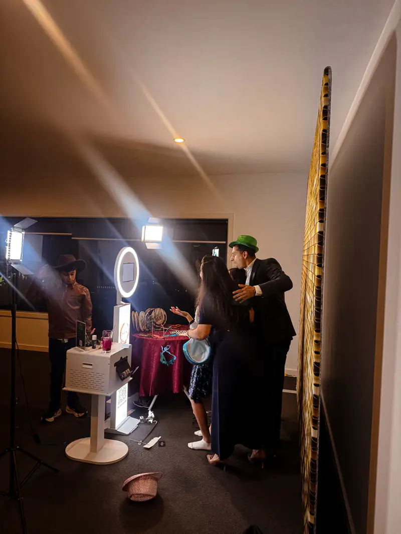 Guests posing at the booth in a function room