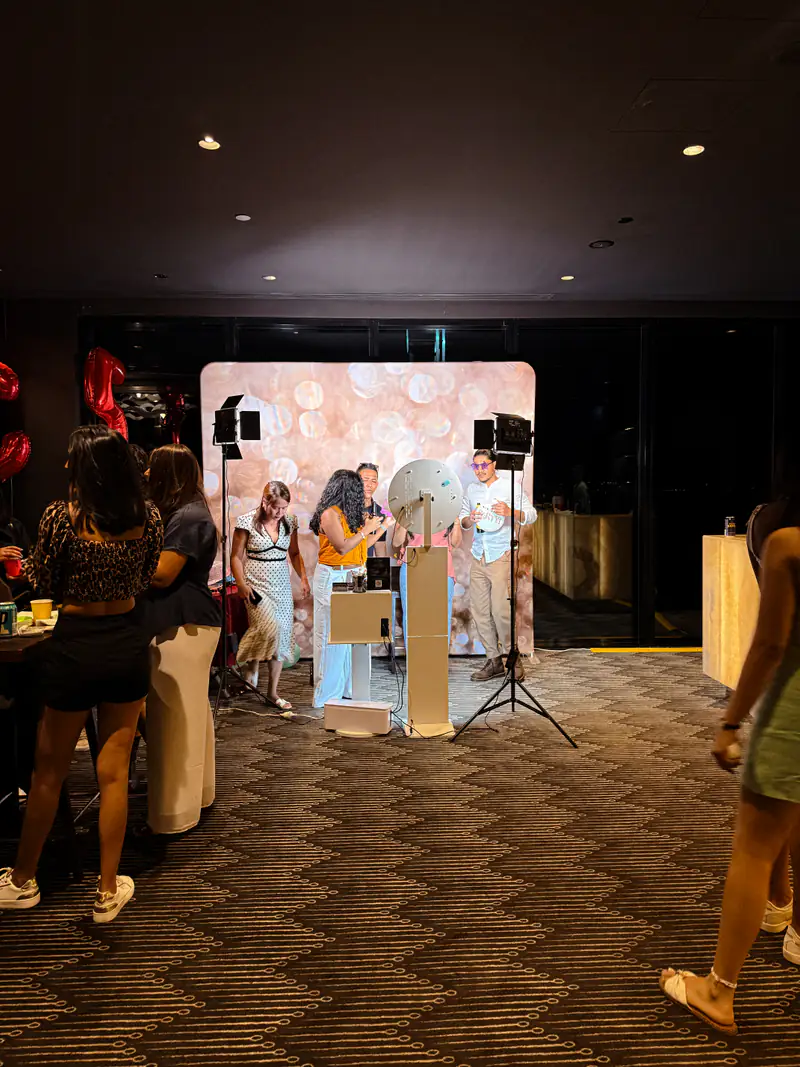 A party in full swing around the booth and backdrop